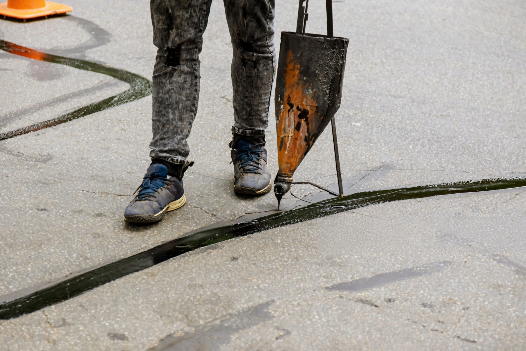 Hot rubberized crack sealing on an asphalt driveway in Knoxville TN