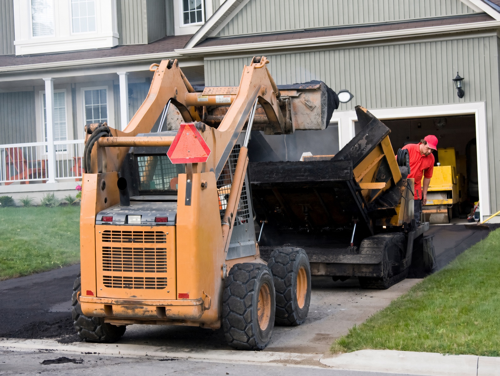 Grading and compacting stone base before paving in Knox County